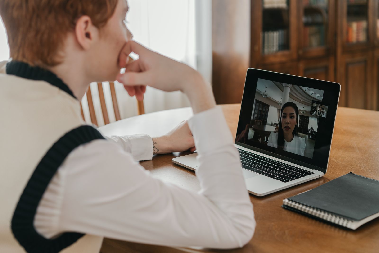 A video appointment running on a laptop at a kitchen table